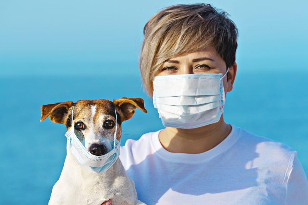 woman and dog wearing face mask