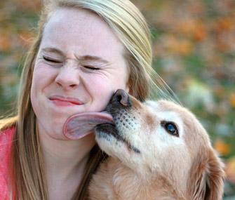 Dog kissing woman's face
